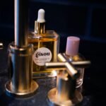 two perfume bottles on black table