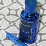 a blue bottle of sharara next to a blue pen