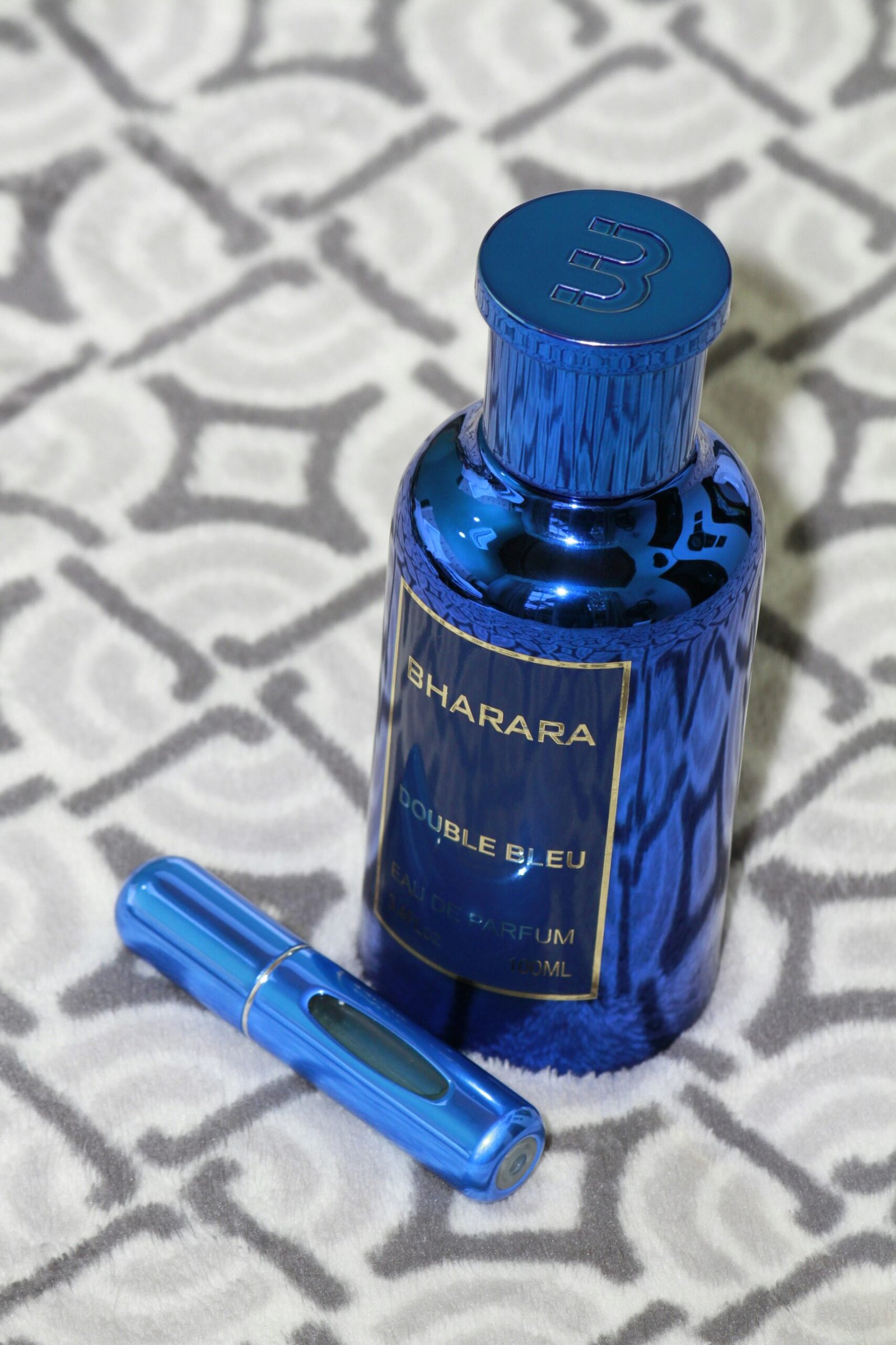 a blue bottle of sharara next to a blue pen